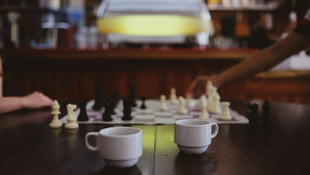 playing chess and drinking coffee at a board game cafe